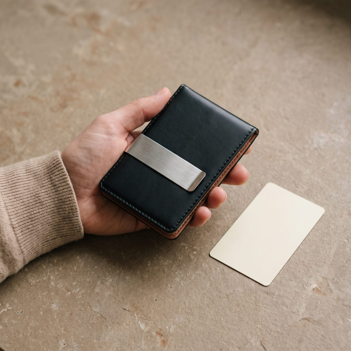 Slim Faux Leather Bifold with Money Clip held in one hand next to a blank card